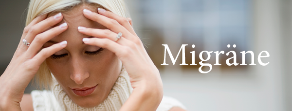Frau mit Migräne hält sich den Kopf